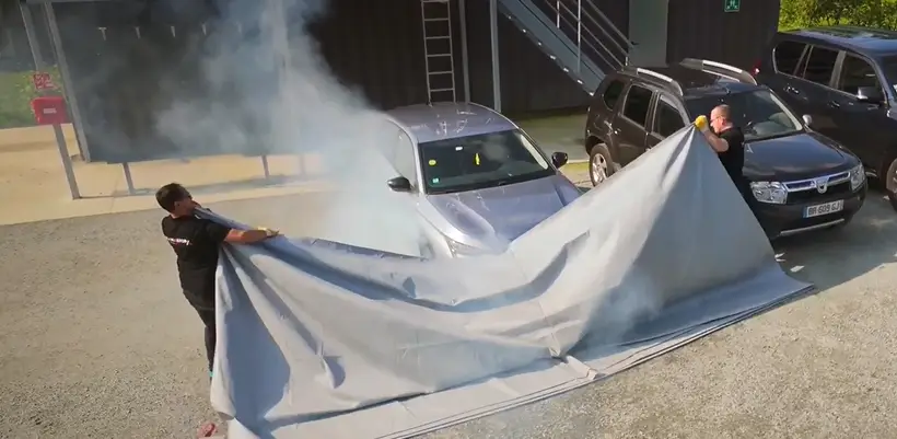 Flamastop employee cover a car with lithium ion accumulator to prevent fire outbreak